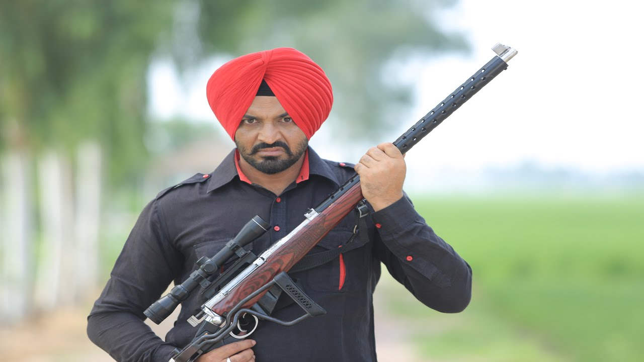 Harinder Bhullar Holding Gun