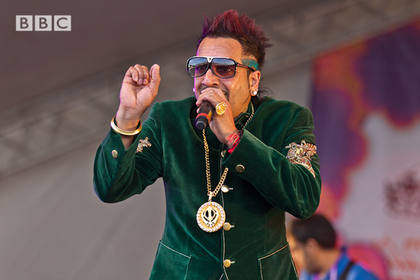 Jazzy B Wearing Green Coat