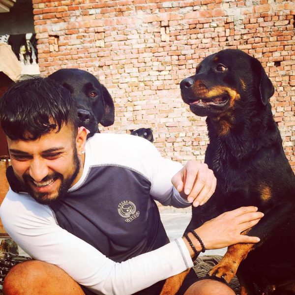 Garry Sandhu Playing With Dogs